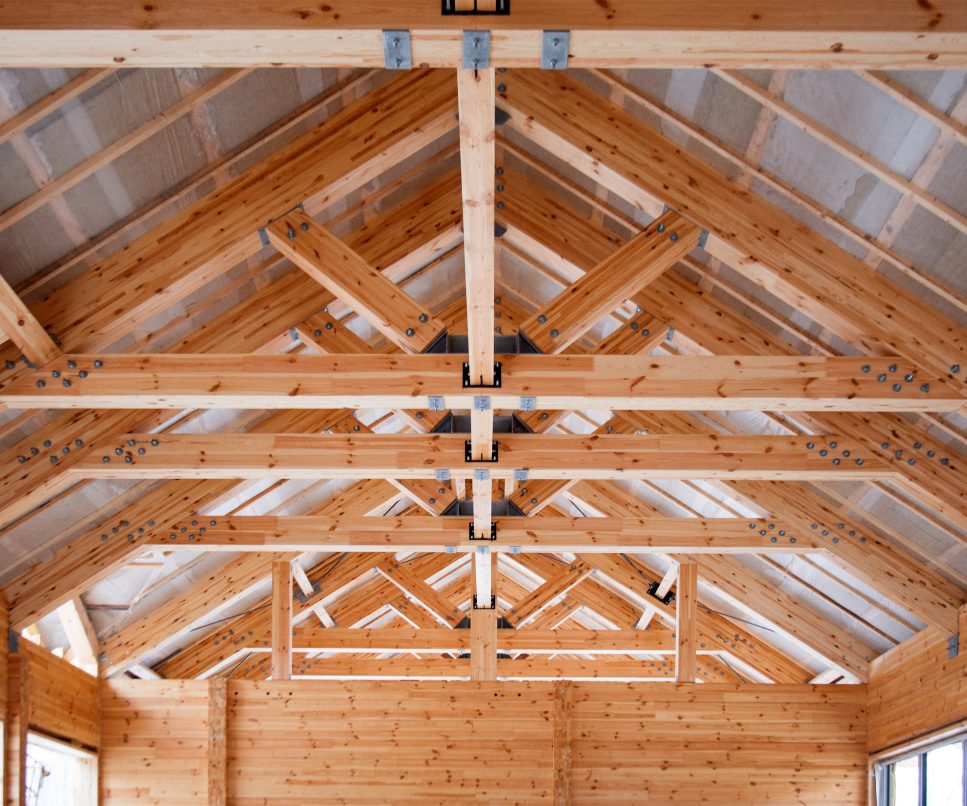 roof construction of big wooden trusses closeup - MW SERVICE